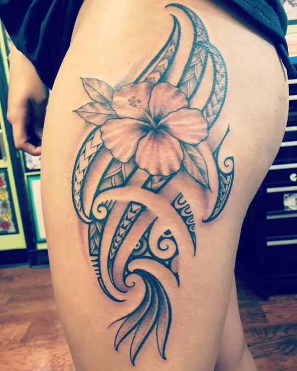 Tribal hibiscus side thigh tattoo for women