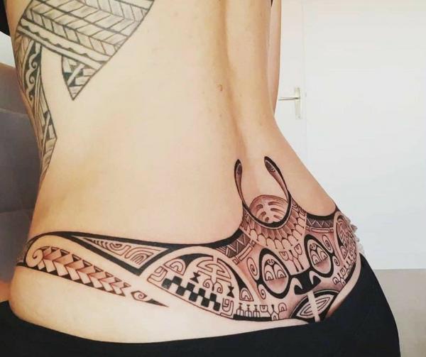 Tribal low back tattoo for women