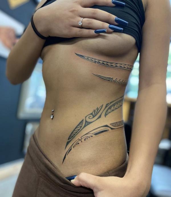 Tribal polynesian side tattoo for woman