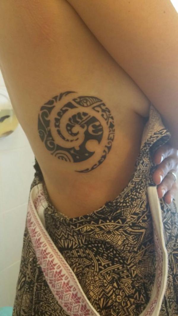 Tribal side tattoo for women