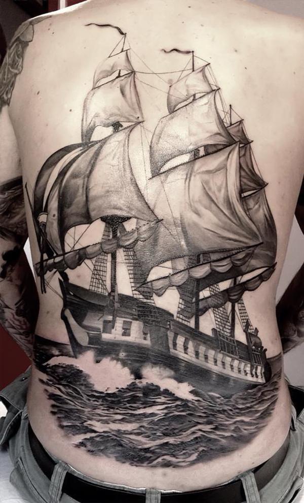 Black and white sailboat tattoo on back