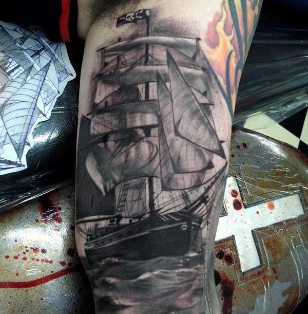 Realism sailboat bicep tattoo black and grey