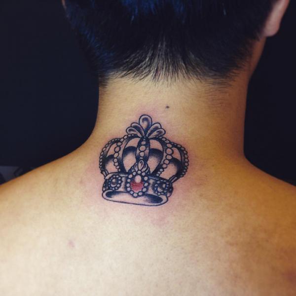 Black crown with a red diamond tattoo on the back of neck
