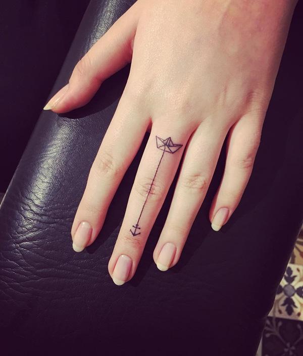 Paper boat finger tattoo