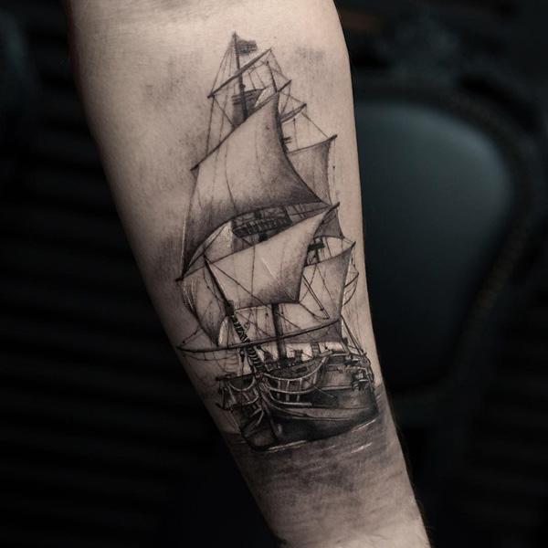 Sailboat tattoo on the inner forearm.