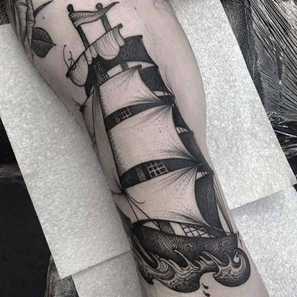 Traditional black and white sailboat tattoo