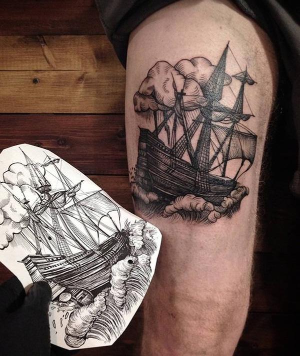 Cloud and ship tattoo on thigh