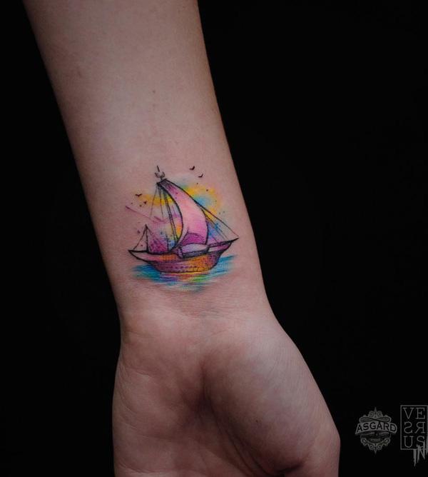 Minimalist boat wrist tattoo in watercolor style