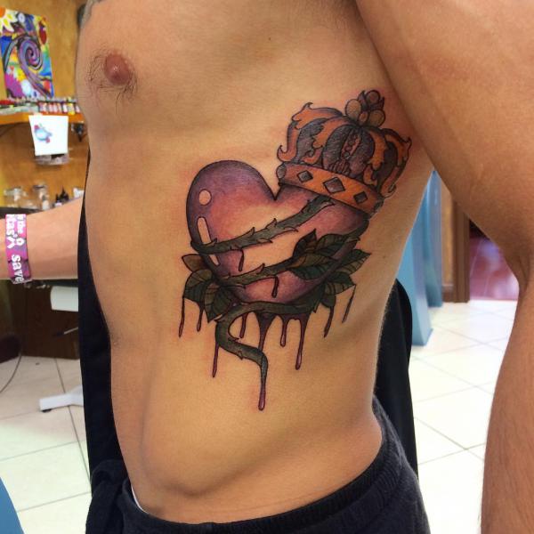 Heart with thorn and crown rib tattoo