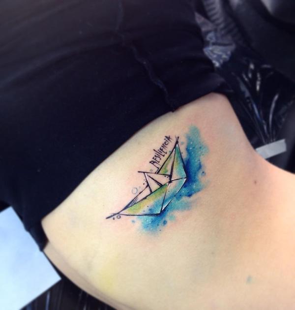 Watercolor paper boat tattoo on side