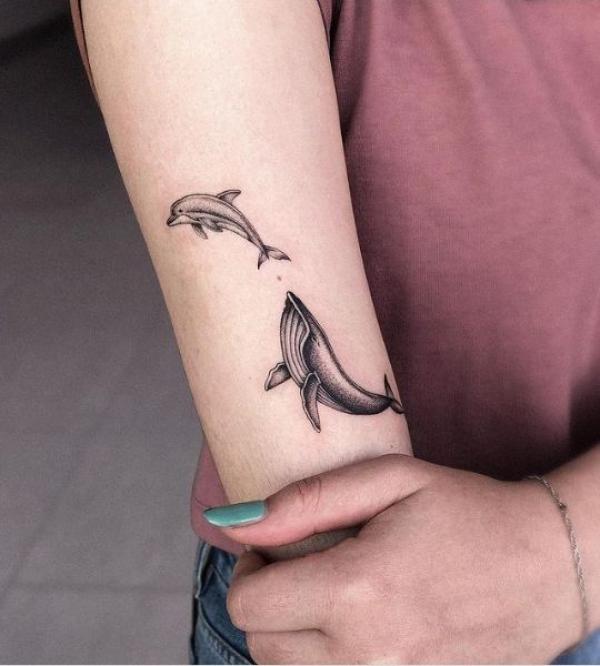 Black and grey dolphin mother and baby tattoo
