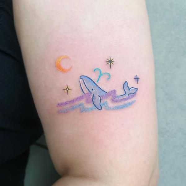 Cute floating dophin with moon and stars tattoo