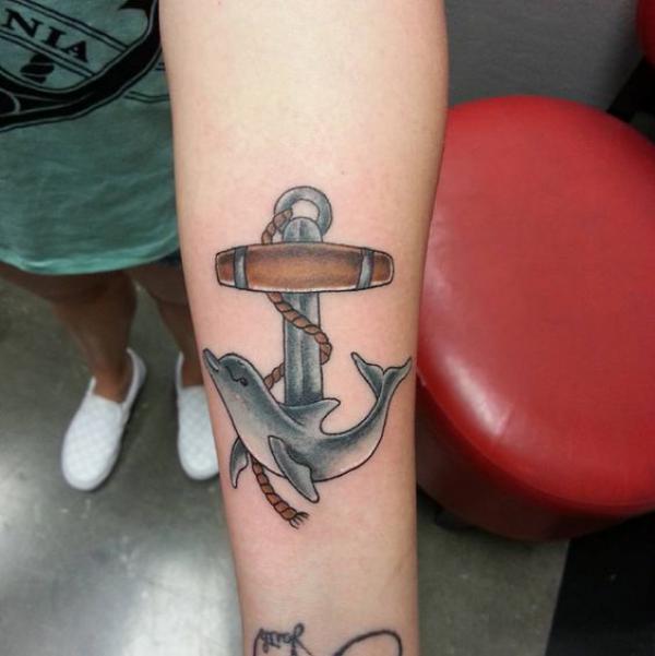 Dolphin and anchor tattoo on forearm