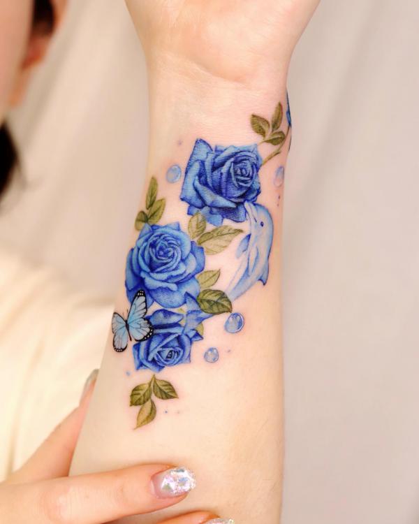 Dolphin and blue roses tattoo