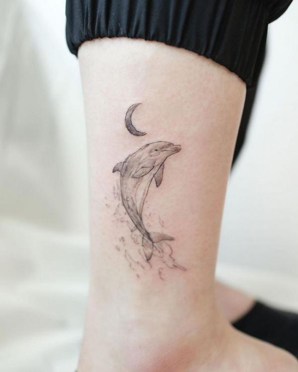 Dolphin and crescent moon tattoo