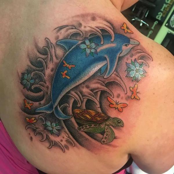 Dolphin and turtle with flowers tattoo