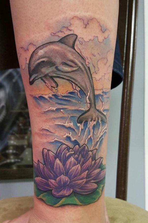 Dolphin and water lily tattoo