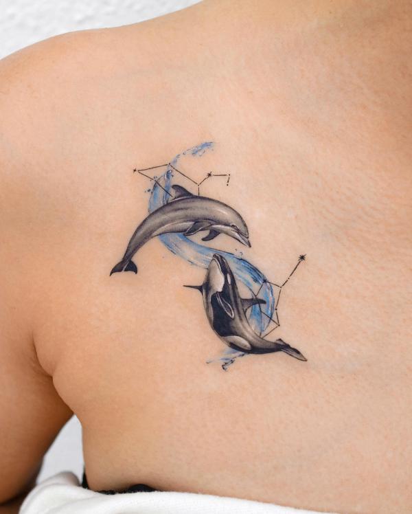 Dolphin and whale with Virgo and Leo constellation tattoo