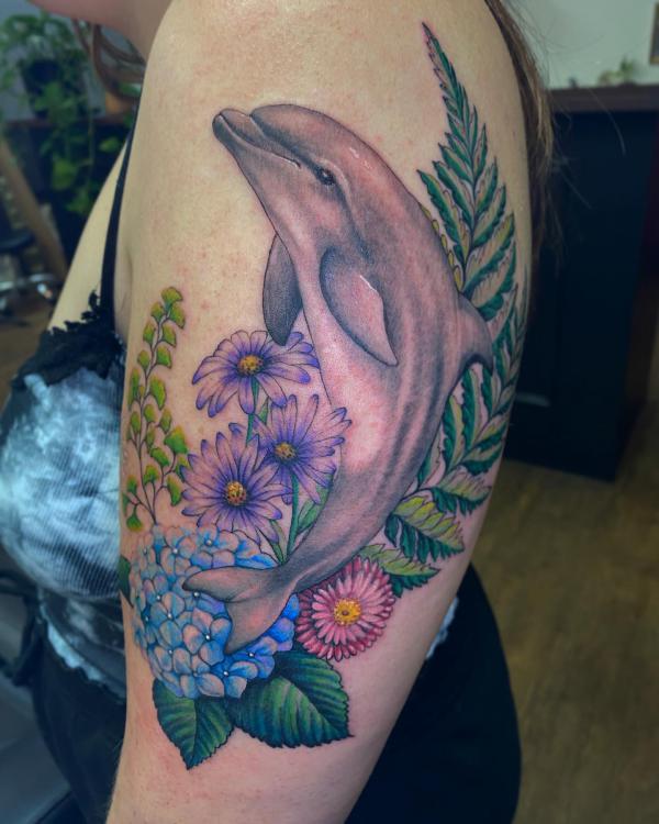 Dolphin daisy and hydrangea tattoo half sleeve