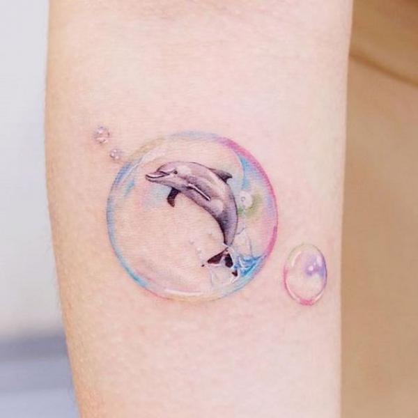 Dolphin in transparent bubble tattoo