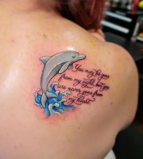 Dolphin jumping out of wave tattoo with quote You may be gone from my sight but you are never gone from my heart
