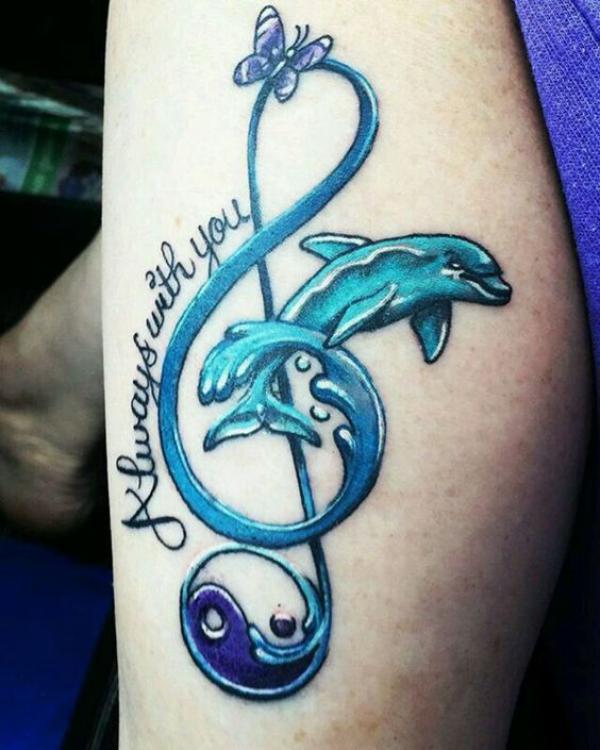 Dolphin jumping through music staff with Yin Yang and butterfly tattoo