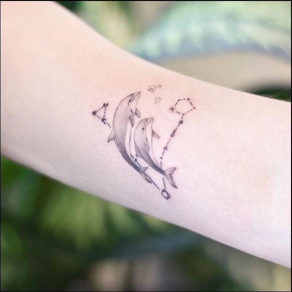 Dolphin with Pisces constellation tattoo
