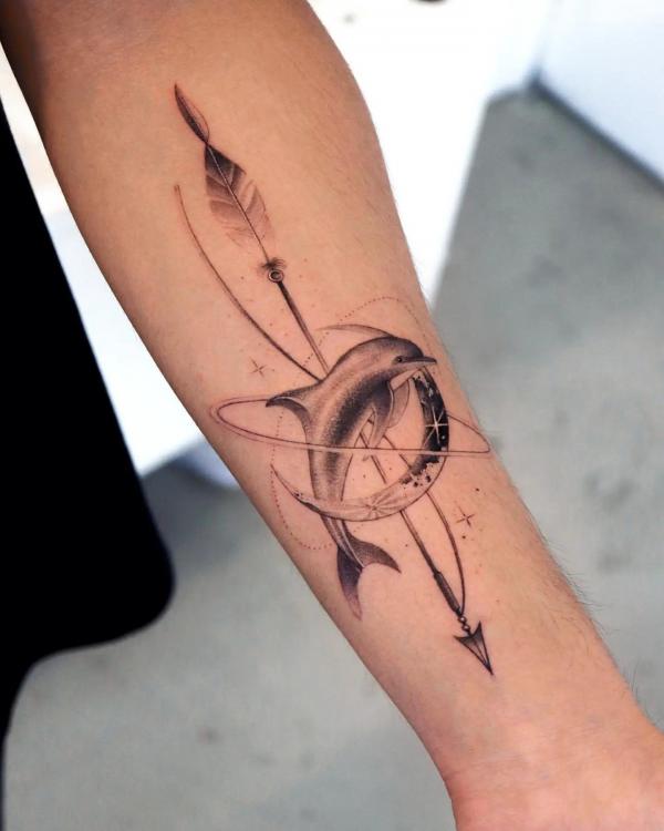 Dolphin with crescent moon and arrow tattoo