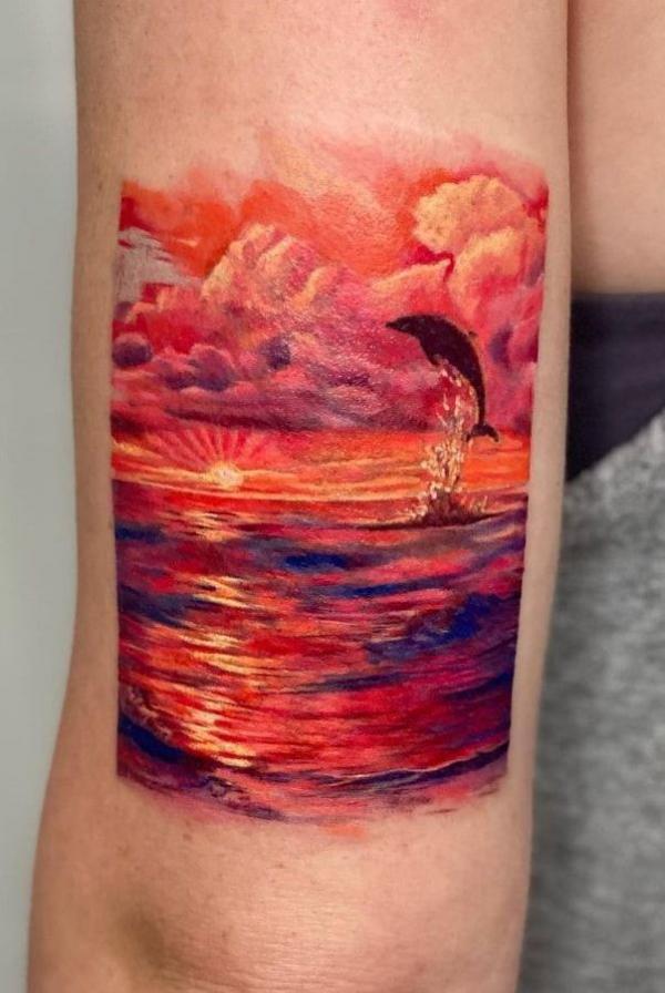 Jumping dolphin sunset tattoo