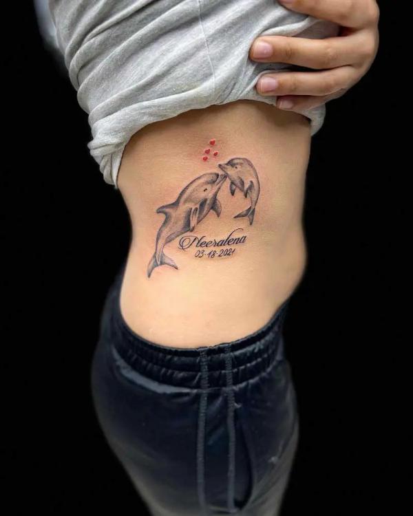Memorial dolphin tattoo with name and date