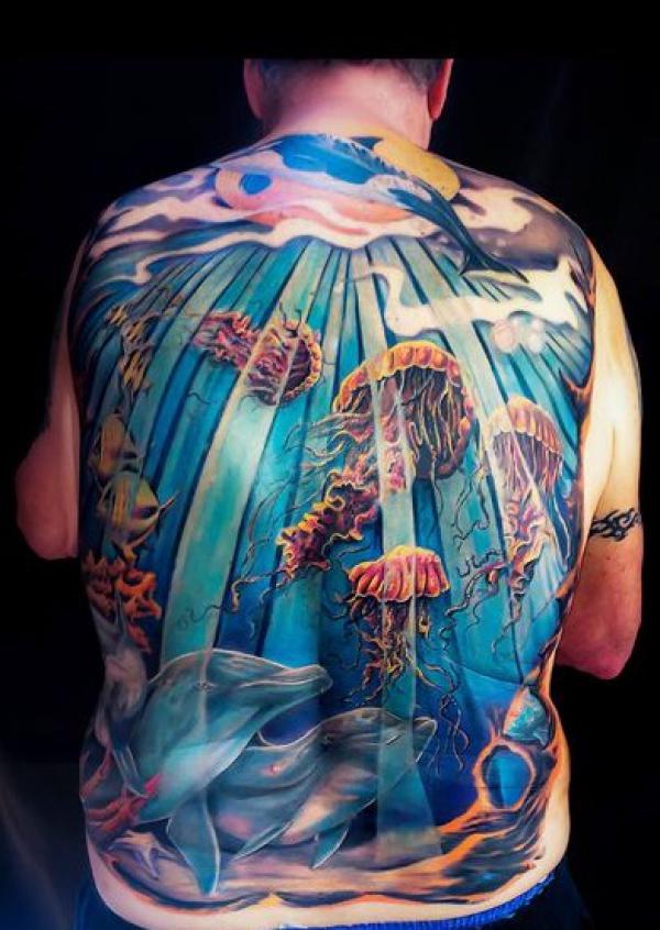 Realistic dolphin and jellyfish full back tattoo