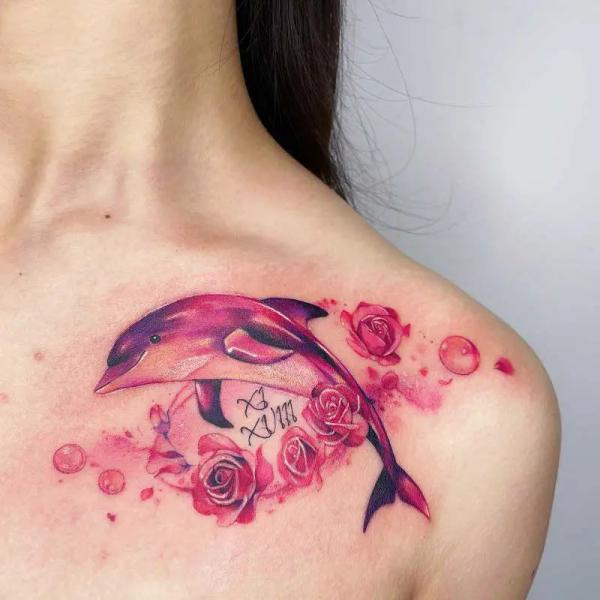 Red dolphin with roses clavicle tattoo