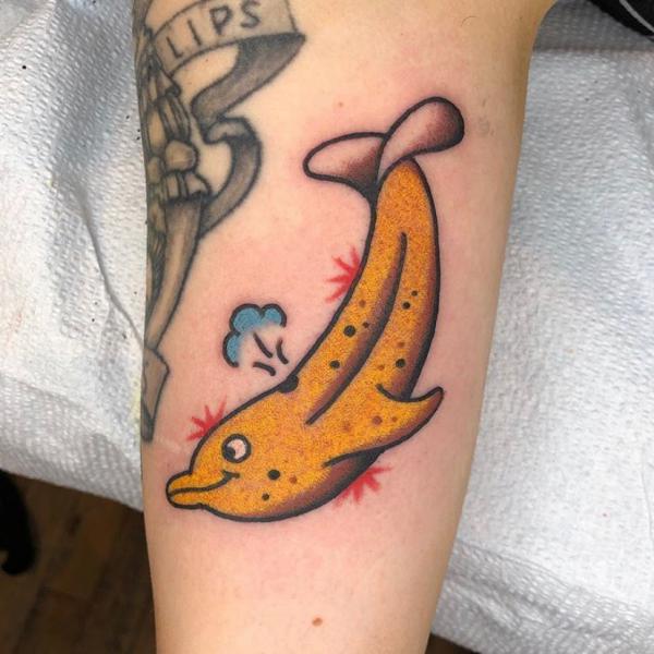 Traditional yellow dolphin tattoo