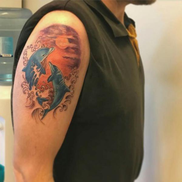 Two dolphin in wave tattoo