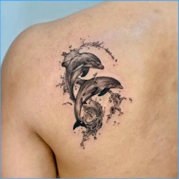 Two jumpin dolphin with wave tattoo