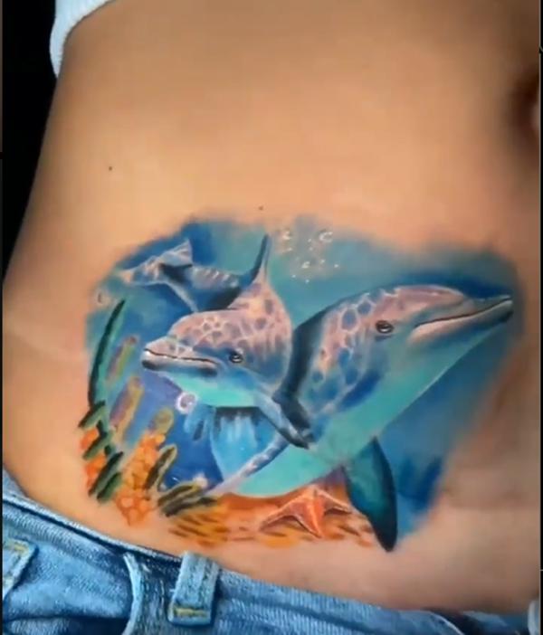Underwater dolphin tatoo on the side of belly