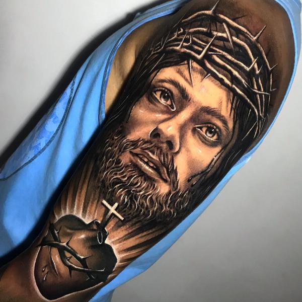 Jesus with crown of thorns and a human heart encircled with barbed wire