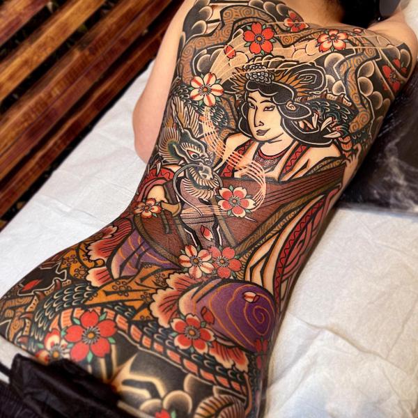 Traditional geisha and dragon back tattoo