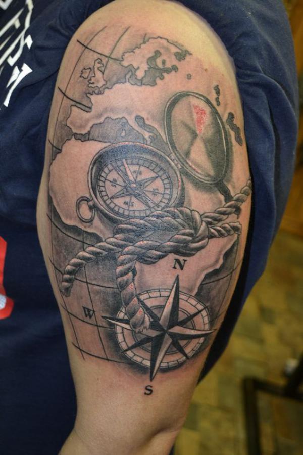Africa and Europe with compass tattoo
