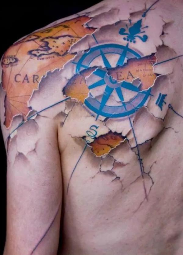 Broken skin map and compass tattoo