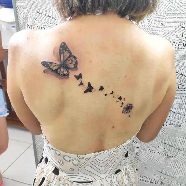 Dandelion butterfly tattoo on back