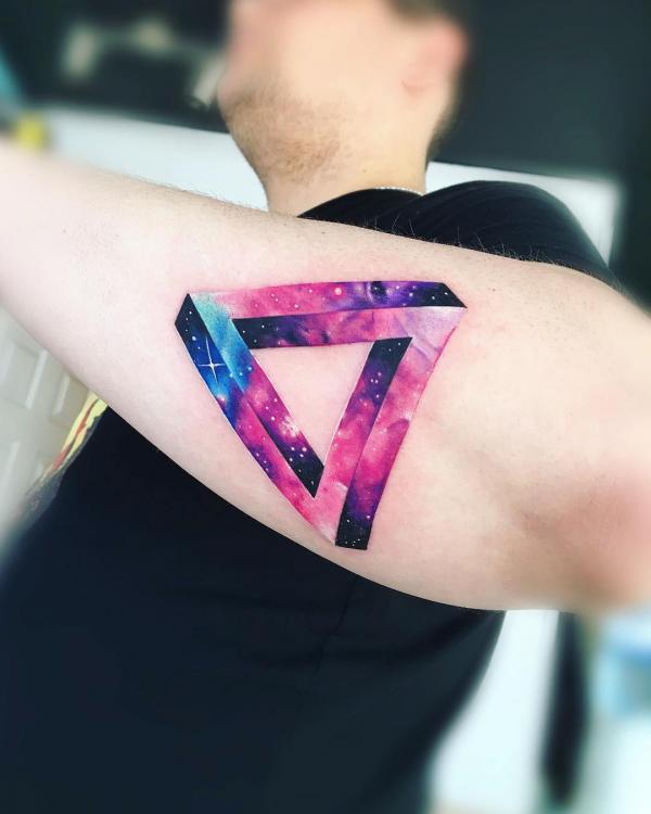 Small penrose triangle tattoo on the left inner wrist.