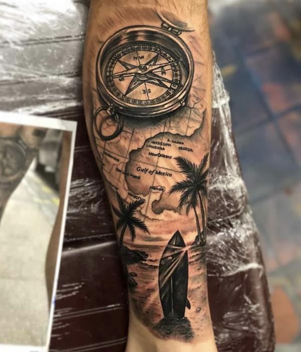 Nautical map and compass with palm tree tattoo