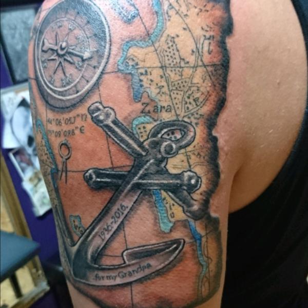 Old map with compass and anchor tattoo