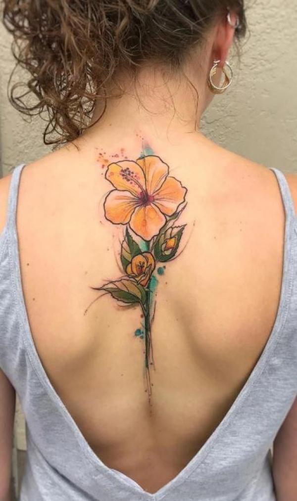 Yellow hibiscus spine tattoo