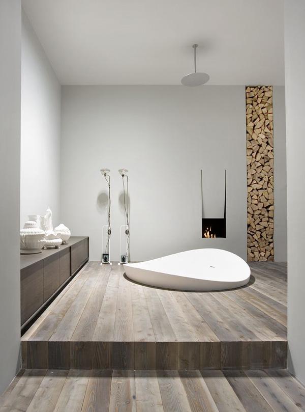 The oval streamlined bathtub in the wooden floor Creative Bathtub design -a white oval streamlined bathtub is embedded in the wooden floor. A cozy looking bathtub that you can step into easily when you want to enjoy a nice evening soak.