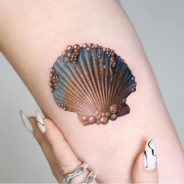 A Scallop shell with pearls tattoo