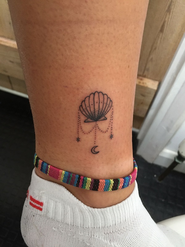 Camino shell with moon and stars pendant tattoo above ankle