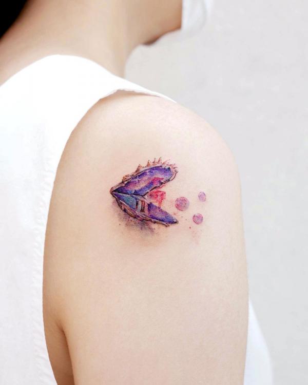 Cute shell with pearl shoulder tattoo