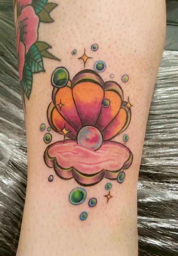 Neo traditional pearl in shell tattoo